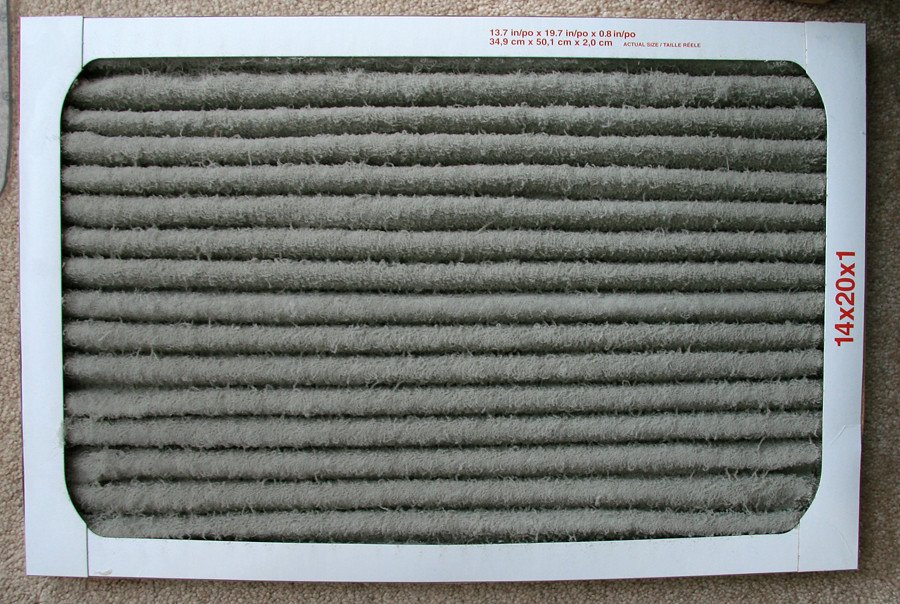 Dirty residential HVAC air filter clogged with dust